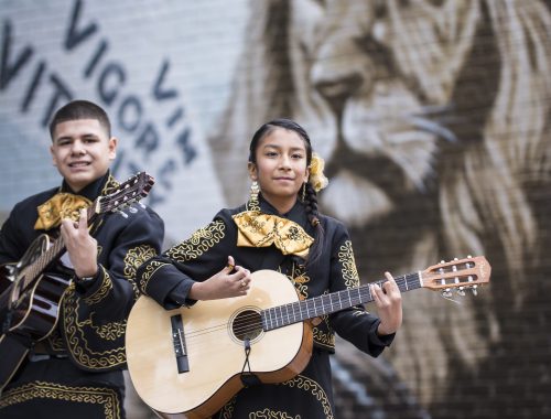 mariachi in front of mural